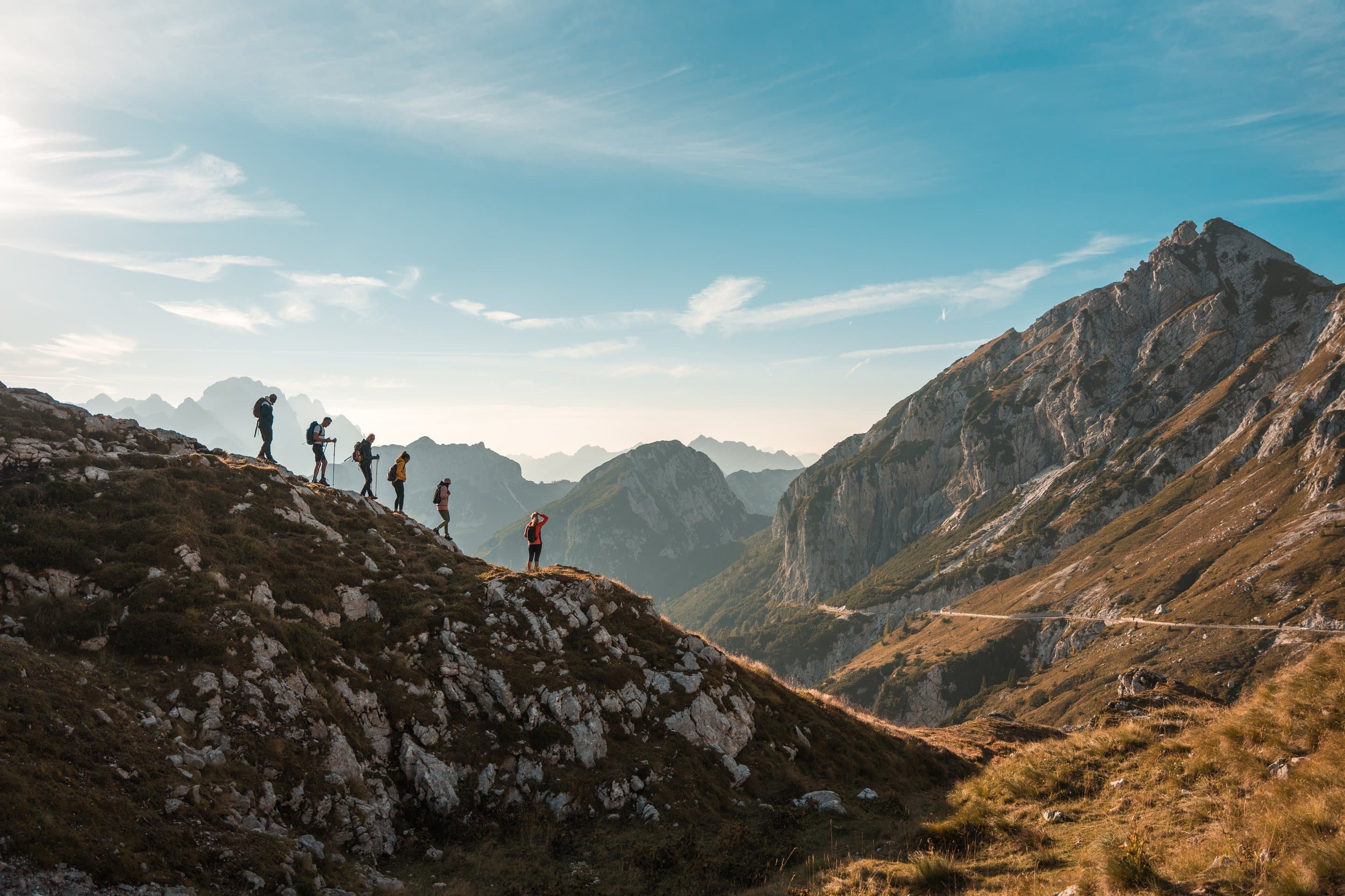 Hikers on a mountain ridge at golden hour